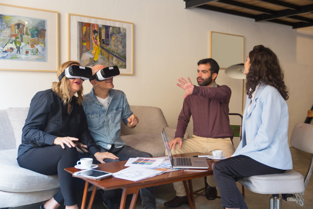 Middle aged customers enjoying VR experience in interior designer office. People using virtual reality technology at home. VR design project concept